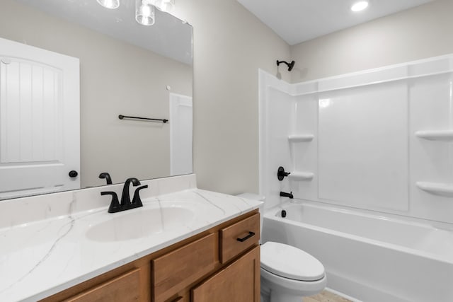 full bathroom with vanity, tub / shower combination, and toilet