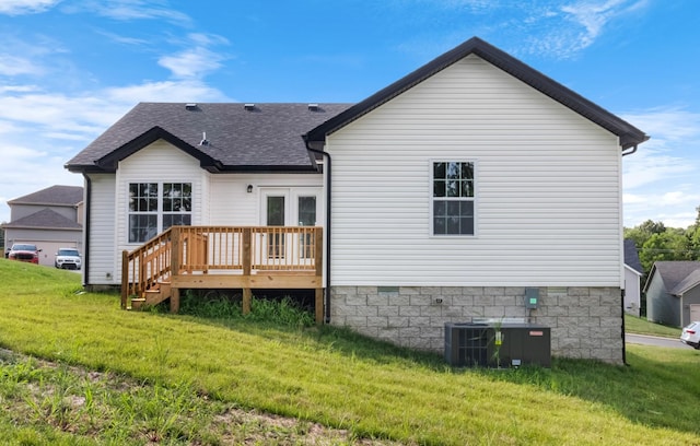 rear view of house with a wooden deck, a yard, cooling unit, and french doors