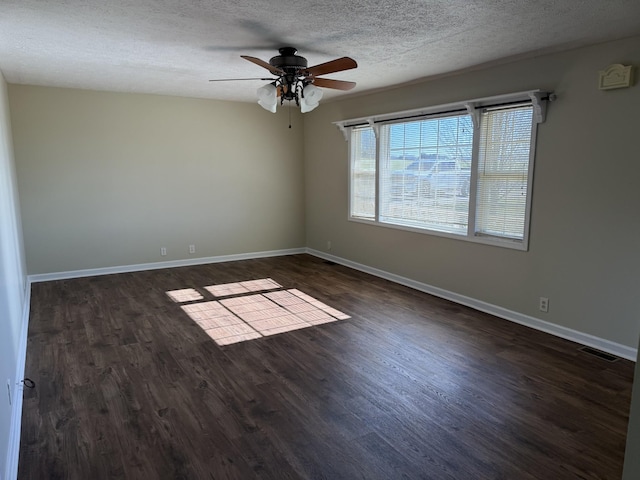 spare room featuring a textured ceiling, ceiling fan, and dark hardwood / wood-style floors