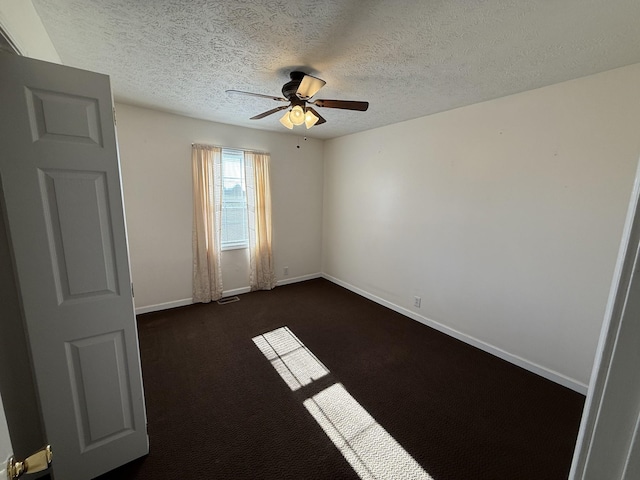 carpeted spare room with ceiling fan and a textured ceiling