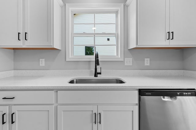 kitchen with white cabinetry, dishwasher, light stone counters, and sink