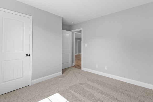 unfurnished bedroom featuring light carpet