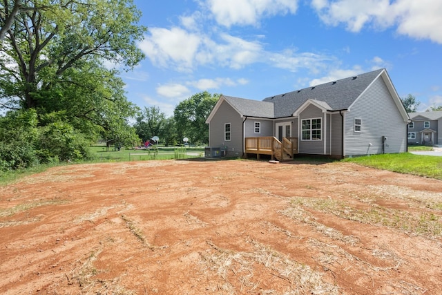 rear view of property featuring a deck and central AC