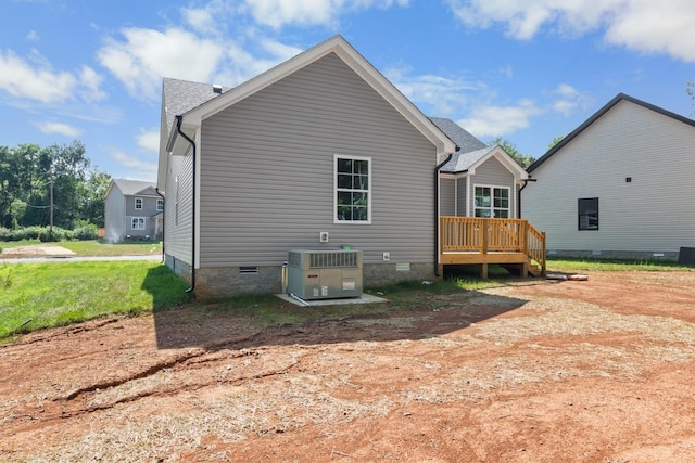 back of property with a deck and central air condition unit