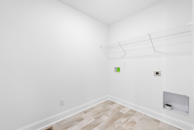 laundry room featuring electric dryer hookup, hookup for a washing machine, and light hardwood / wood-style floors