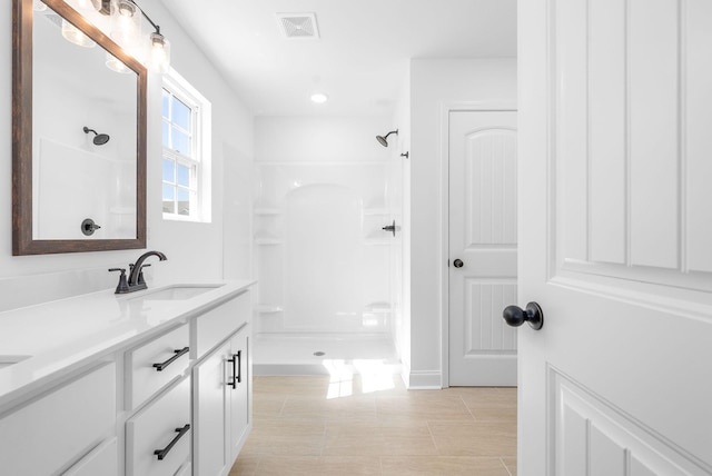 bathroom featuring vanity and walk in shower