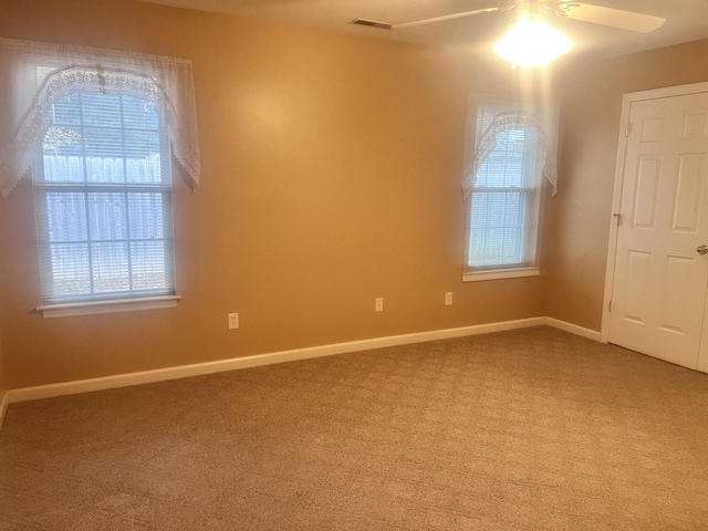 carpeted empty room featuring ceiling fan