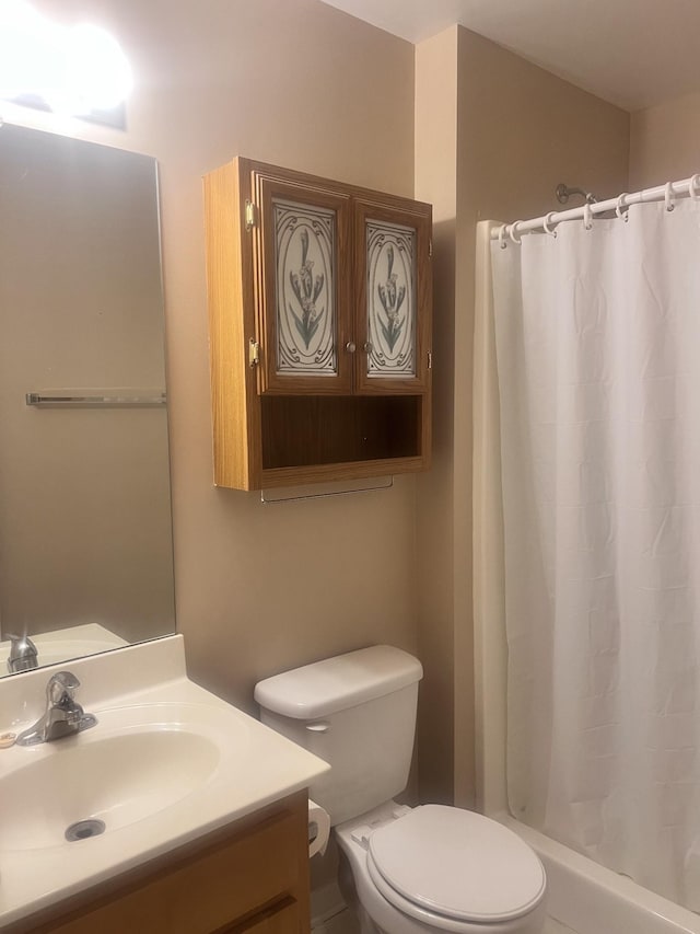 bathroom featuring vanity, toilet, and walk in shower