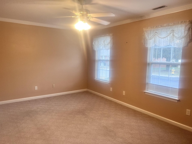 carpeted empty room featuring ceiling fan and ornamental molding