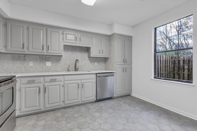 kitchen with dishwasher, decorative backsplash, range with electric stovetop, and sink