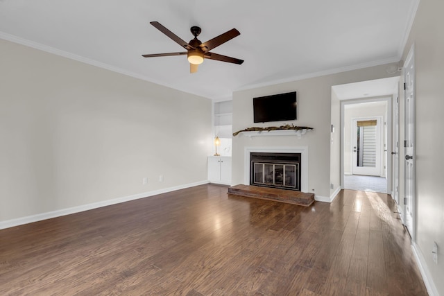 unfurnished living room with crown molding, ceiling fan, and dark wood-type flooring