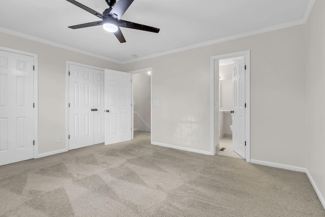 unfurnished bedroom with ensuite bath, ceiling fan, light colored carpet, and ornamental molding