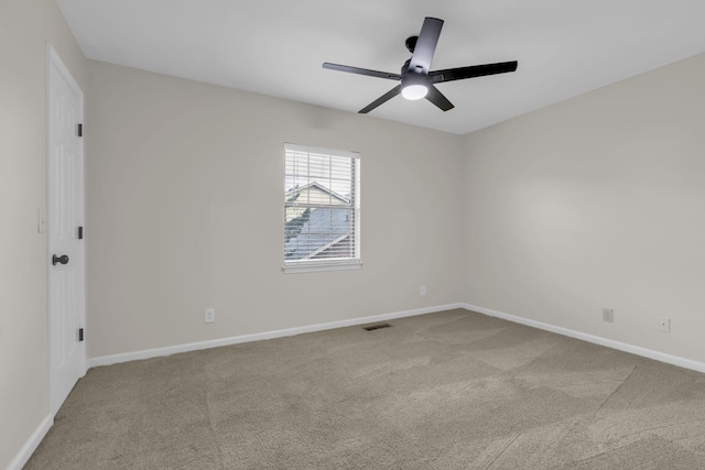 empty room featuring ceiling fan and carpet floors