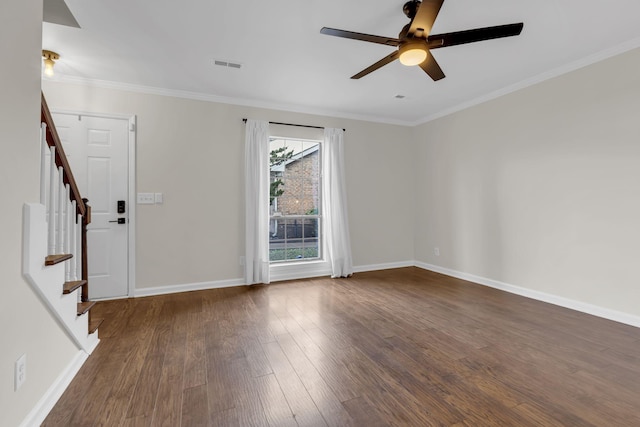 spare room with dark hardwood / wood-style flooring, ceiling fan, and ornamental molding