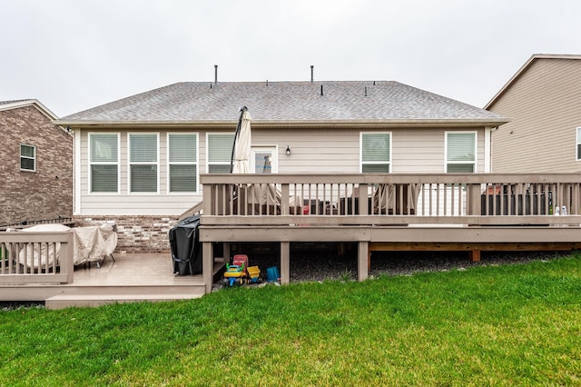 back of house featuring a yard and a wooden deck