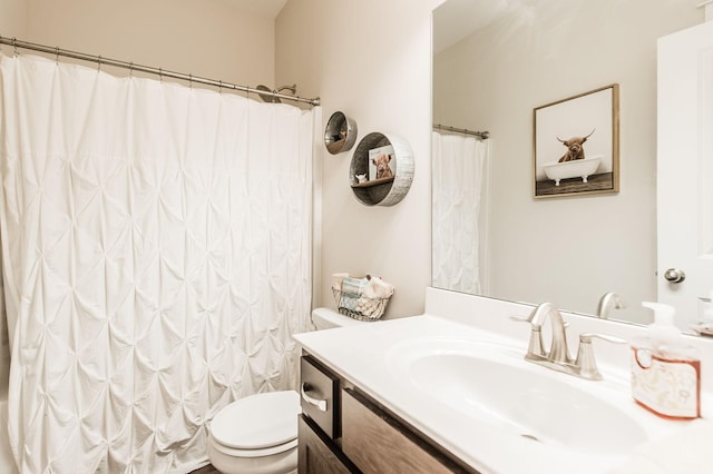 bathroom featuring vanity, curtained shower, and toilet