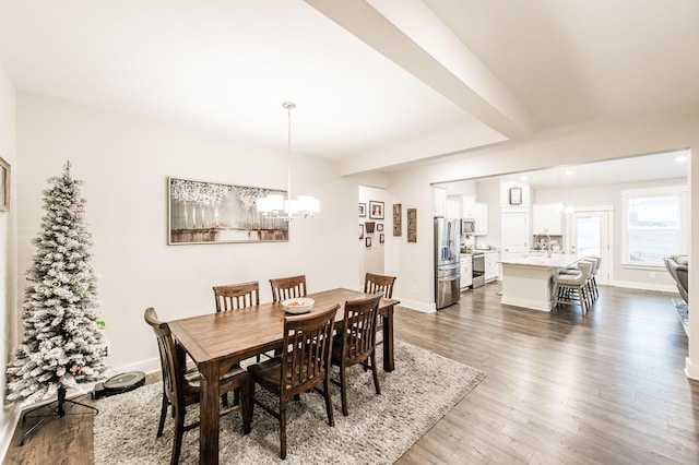 dining space featuring a chandelier and dark hardwood / wood-style flooring