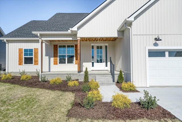 view of exterior entry with covered porch, a yard, and a garage