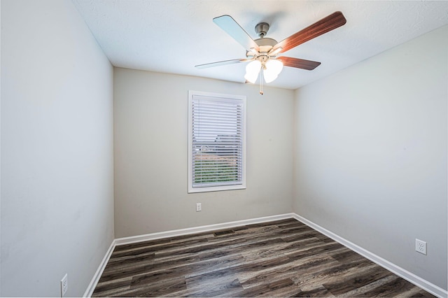 spare room featuring ceiling fan and dark wood-type flooring