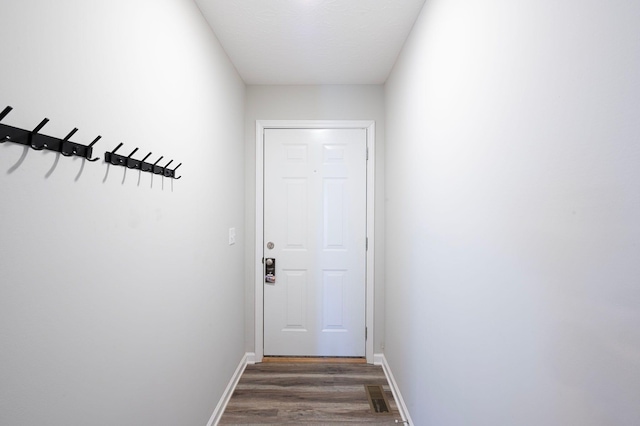 entryway with dark hardwood / wood-style flooring