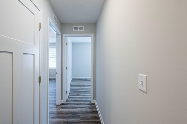 hall featuring dark wood-type flooring