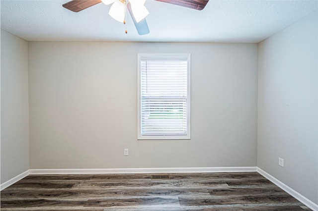 spare room featuring a textured ceiling, ceiling fan, and dark wood-type flooring