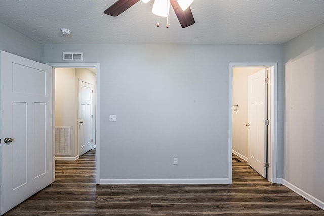 unfurnished room with dark hardwood / wood-style floors, ceiling fan, and a textured ceiling