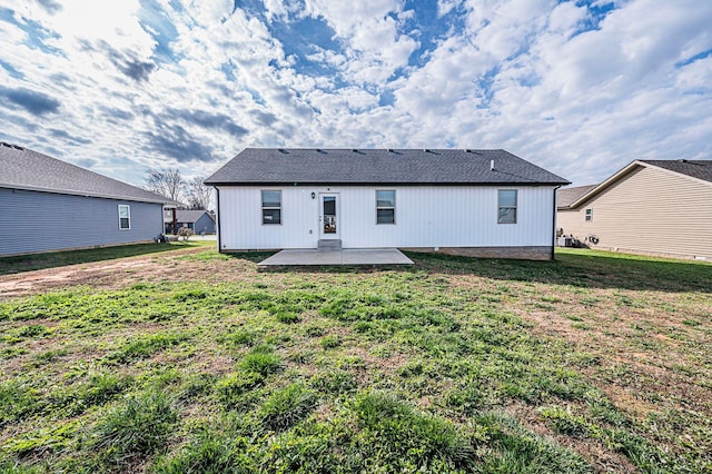 back of house featuring a lawn and a patio