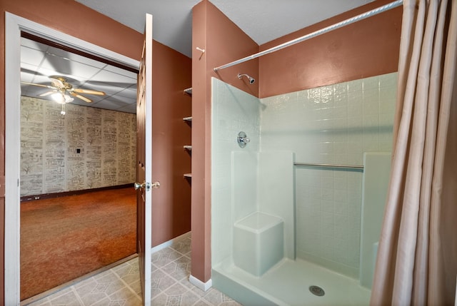 bathroom with ceiling fan and curtained shower