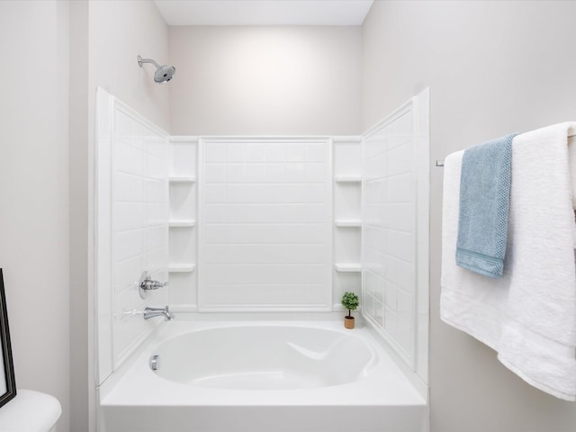 bathroom featuring shower / bathtub combination and toilet