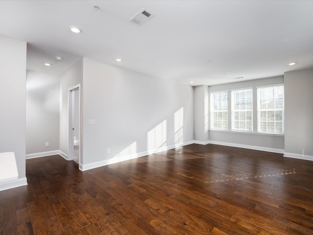 unfurnished room with dark wood-type flooring