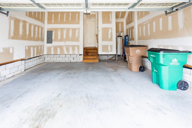 garage featuring electric panel and water heater