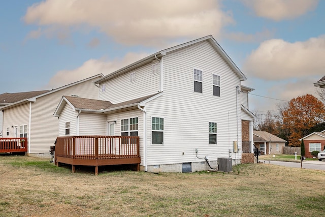 rear view of house featuring a lawn, a wooden deck, and central AC