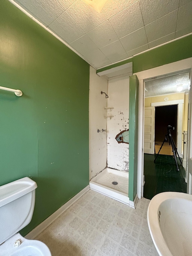 bathroom featuring toilet and walk in shower