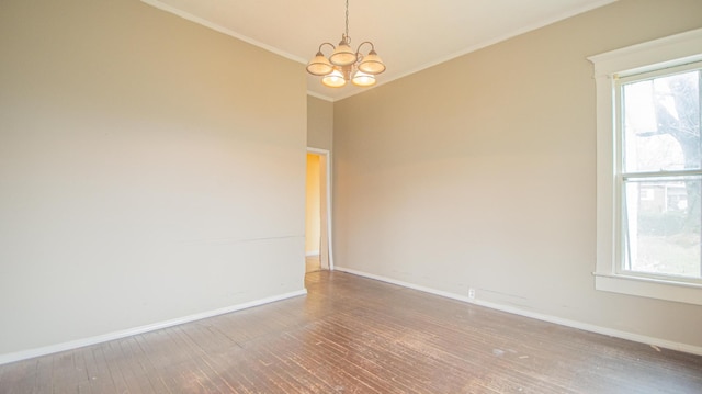 unfurnished room featuring ornamental molding, wood-type flooring, and an inviting chandelier