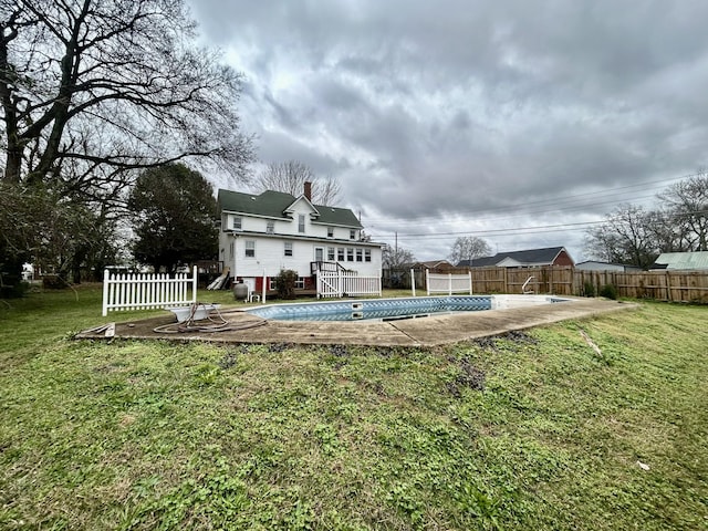 exterior space featuring a swimming pool side deck, a yard, and a patio area