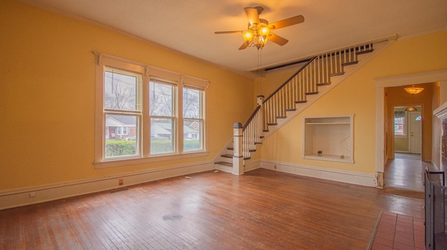 unfurnished living room with ceiling fan and wood-type flooring