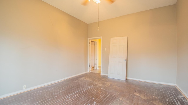 empty room with ceiling fan, dark hardwood / wood-style flooring, and high vaulted ceiling