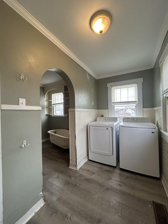 laundry area featuring separate washer and dryer, crown molding, plenty of natural light, and dark wood-type flooring