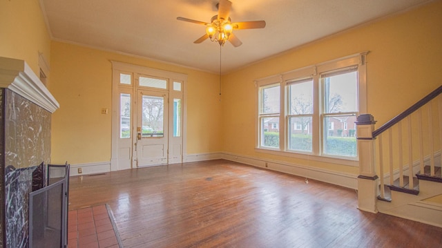 foyer entrance featuring ceiling fan, wood-type flooring, and ornamental molding