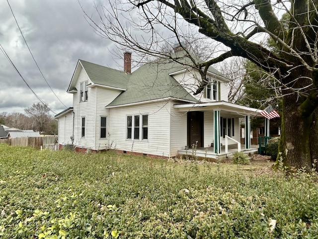 back of property with a porch