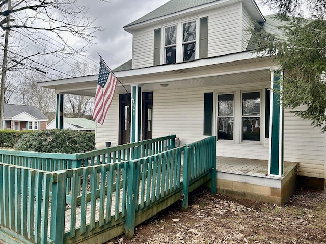 rear view of property featuring a porch