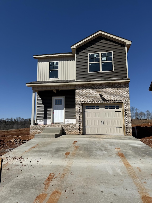 view of front of property with covered porch, driveway, board and batten siding, and an attached garage