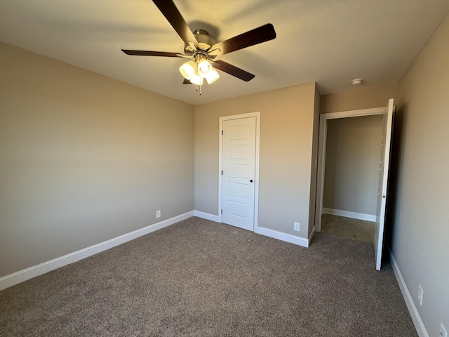 unfurnished bedroom featuring a ceiling fan, dark colored carpet, and baseboards