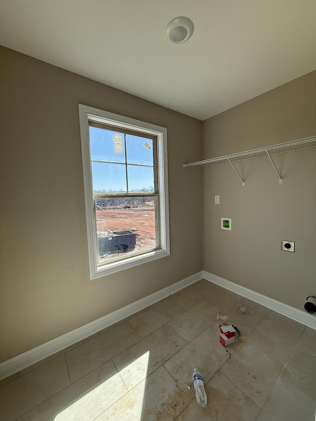 laundry area featuring laundry area, light tile patterned floors, baseboards, hookup for a washing machine, and hookup for an electric dryer