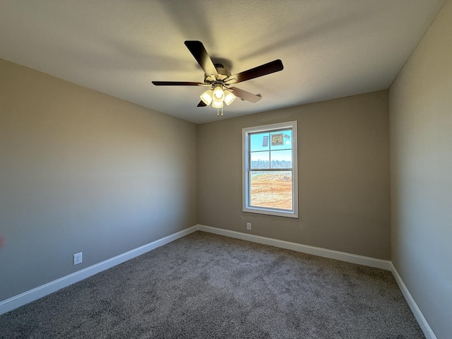 empty room featuring a ceiling fan, carpet floors, and baseboards