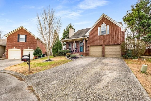 front of property with a front lawn, a porch, and a garage