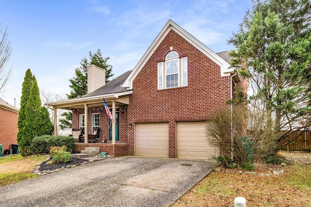 view of front of home with covered porch and a garage