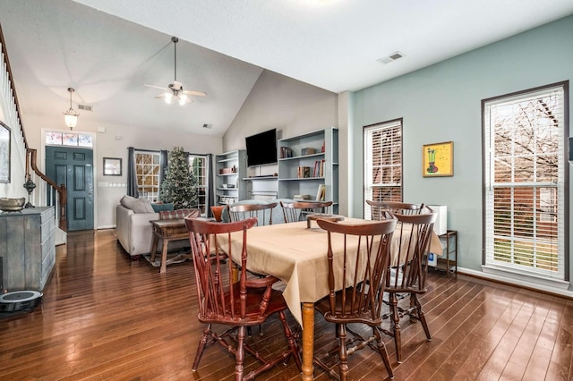 dining space featuring vaulted ceiling, plenty of natural light, and dark wood-type flooring