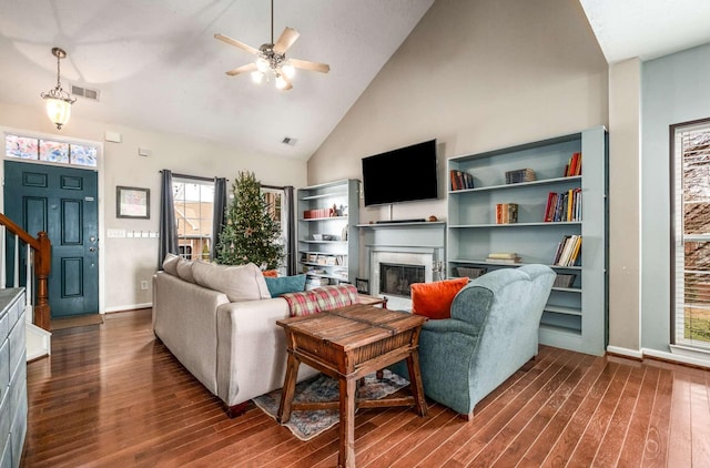 living room with high vaulted ceiling, ceiling fan, and dark wood-type flooring